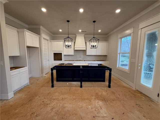 kitchen featuring recessed lighting, a kitchen island, white cabinetry, custom exhaust hood, and crown molding