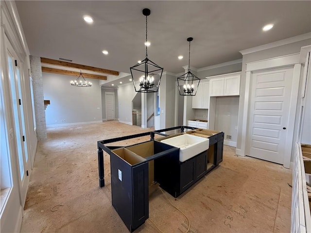 kitchen featuring a center island with sink, white cabinets, beamed ceiling, and recessed lighting