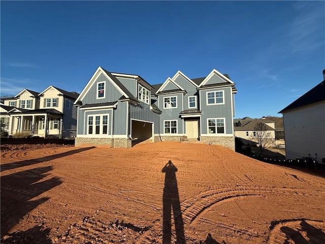 view of front of property featuring a standing seam roof, metal roof, and board and batten siding