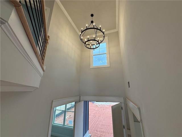 details with ornamental molding and a chandelier