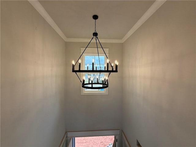 room details with ornamental molding, a notable chandelier, and baseboards