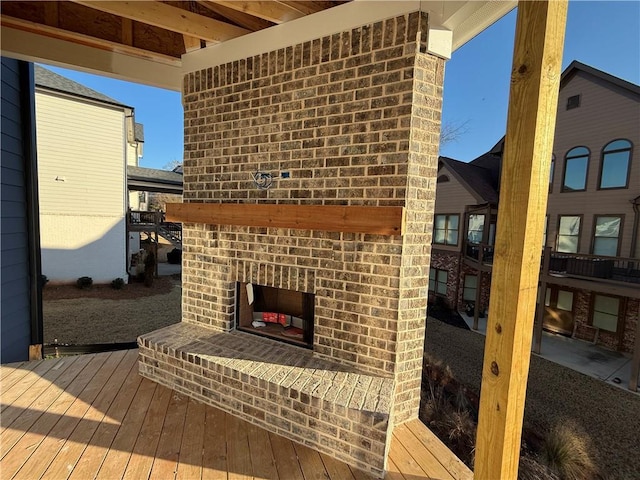 deck with an outdoor brick fireplace