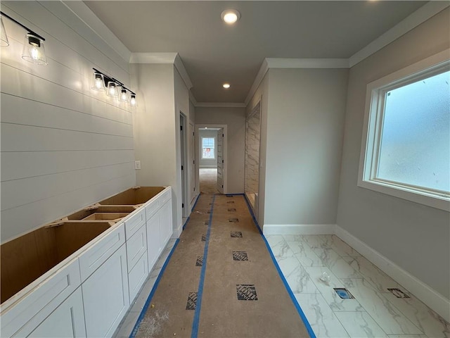 corridor with crown molding, marble finish floor, recessed lighting, and baseboards