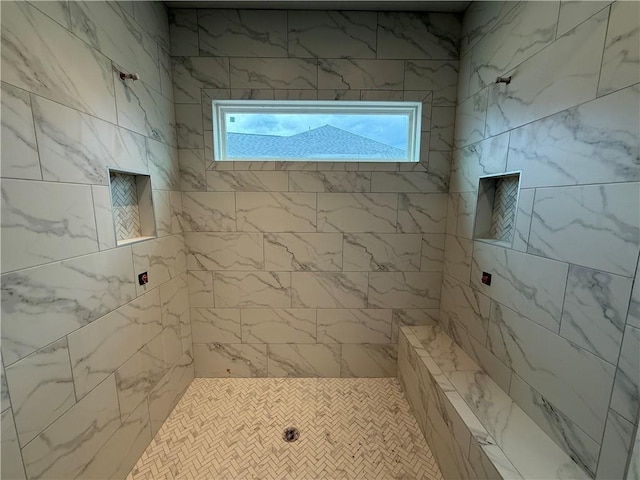 bathroom with a tile shower