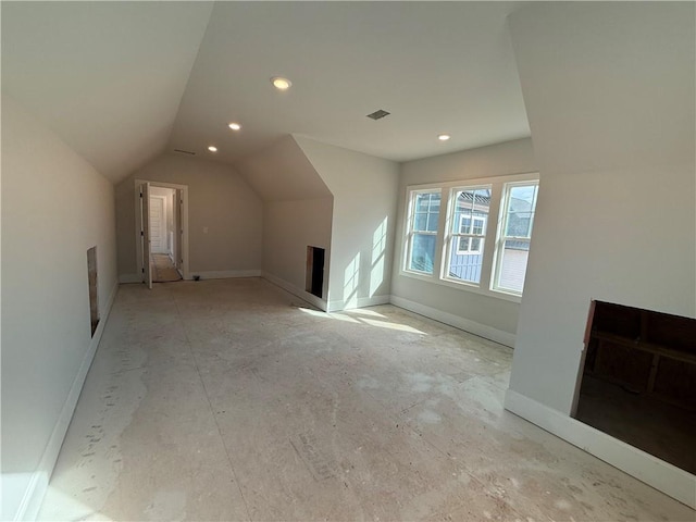 additional living space with recessed lighting, visible vents, vaulted ceiling, and baseboards