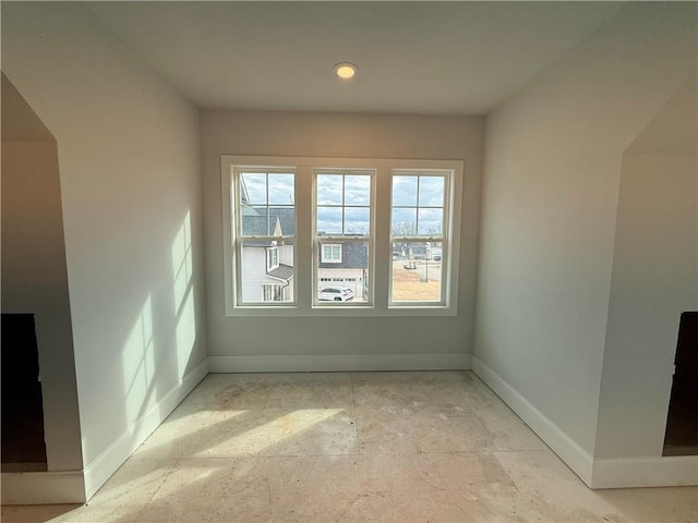 spare room featuring baseboards