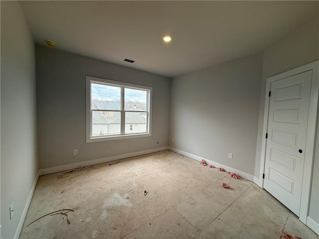 empty room with visible vents and baseboards