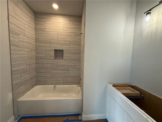 bathroom with washtub / shower combination and baseboards