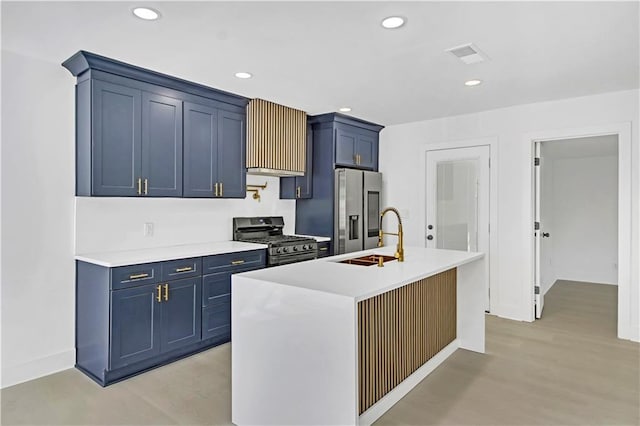 kitchen featuring recessed lighting, blue cabinets, a sink, light countertops, and appliances with stainless steel finishes