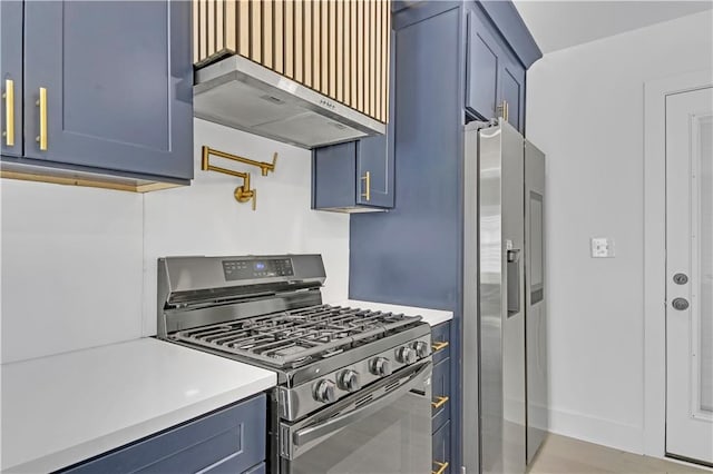 kitchen featuring blue cabinetry, extractor fan, and appliances with stainless steel finishes