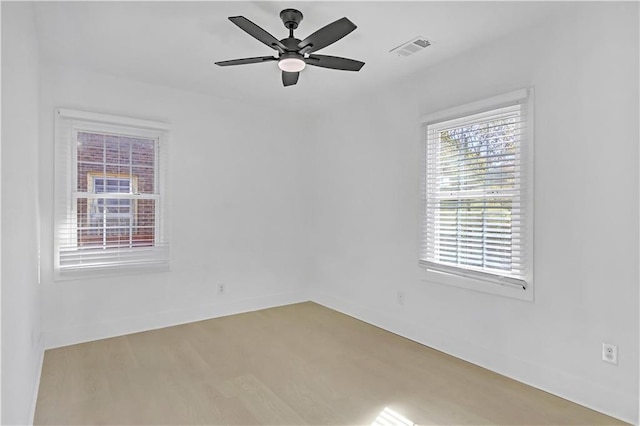 empty room with hardwood / wood-style floors and ceiling fan