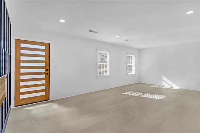 spare room with light wood-style flooring, visible vents, baseboards, and recessed lighting