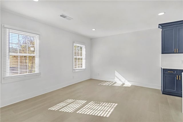 spare room featuring light hardwood / wood-style flooring