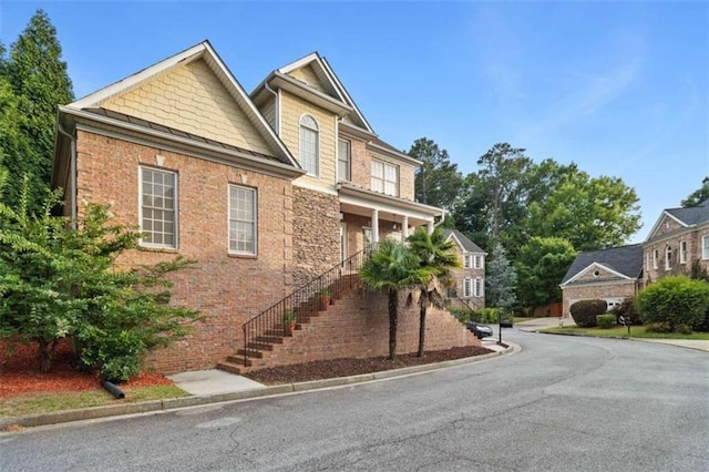 craftsman inspired home with brick siding and stairs