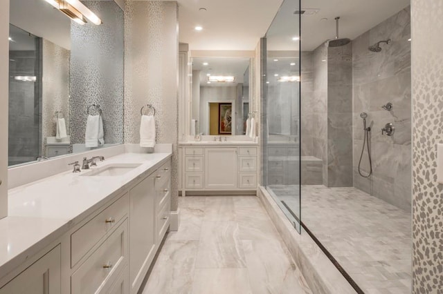 bathroom with vanity and a tile shower