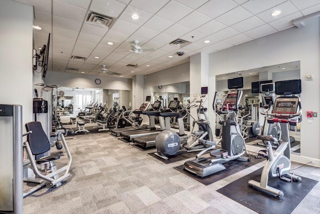 gym featuring ceiling fan, a paneled ceiling, and carpet