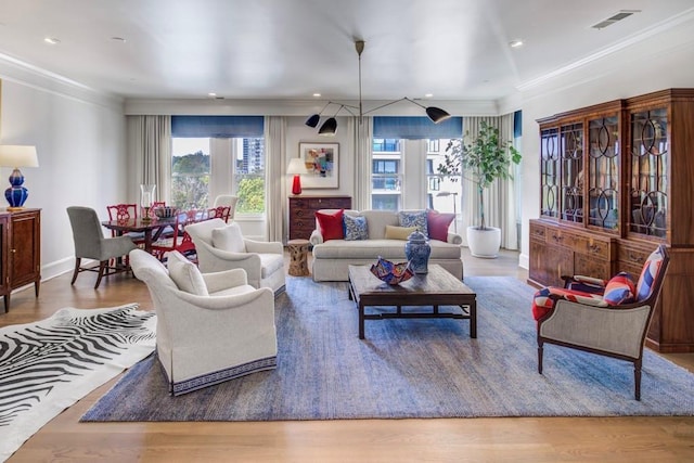 living room with hardwood / wood-style flooring and crown molding