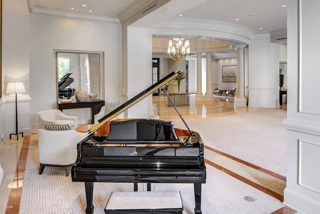 miscellaneous room featuring an inviting chandelier, crown molding, and decorative columns