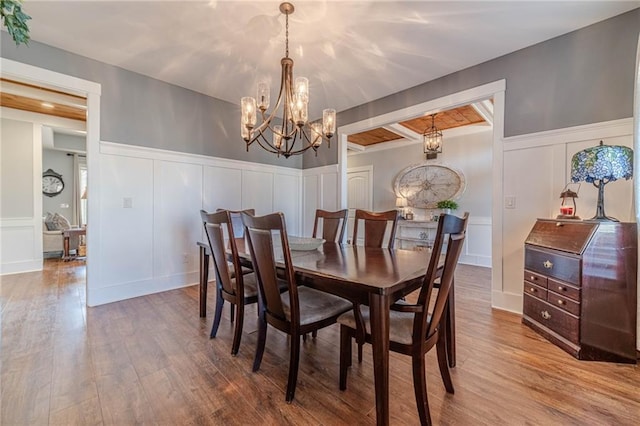 dining area featuring an inviting chandelier and hardwood / wood-style flooring