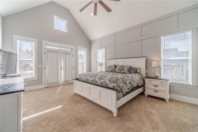 bedroom featuring multiple windows, lofted ceiling, light carpet, and ceiling fan