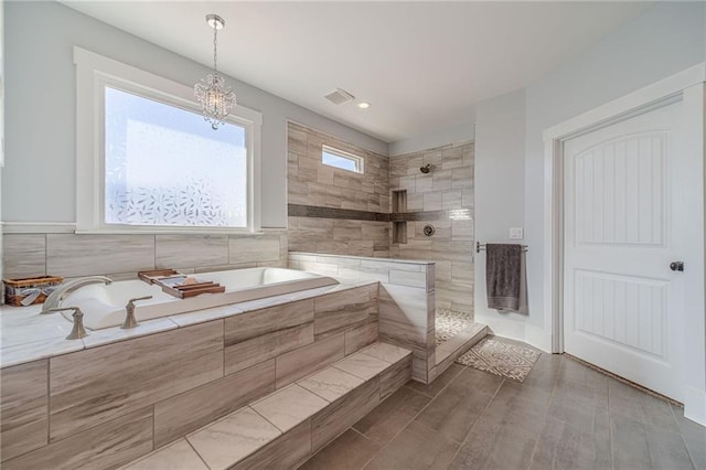 bathroom featuring independent shower and bath