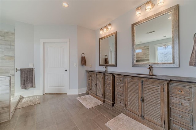 bathroom with walk in shower and vanity