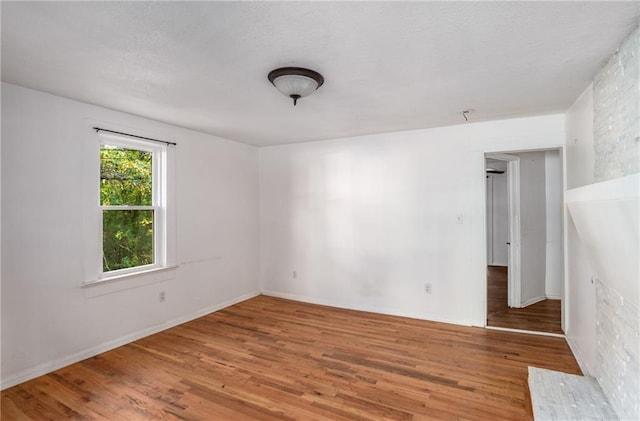 unfurnished room featuring hardwood / wood-style floors