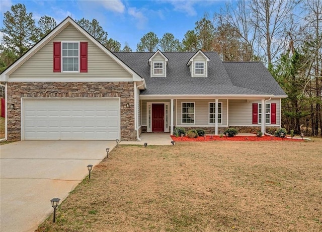 view of front facade featuring a garage, covered porch, and a front lawn