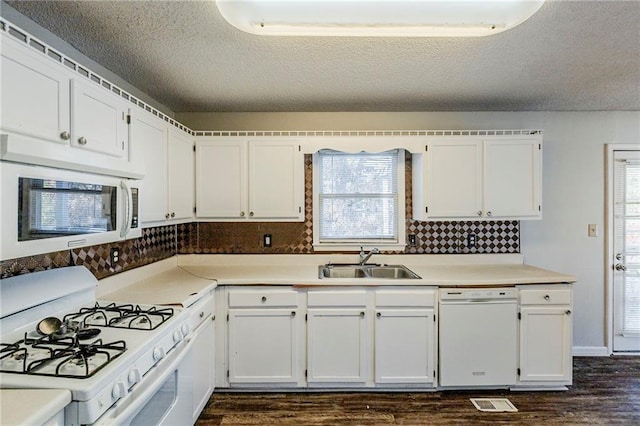 kitchen featuring white cabinets, white appliances, sink, and dark wood-type flooring