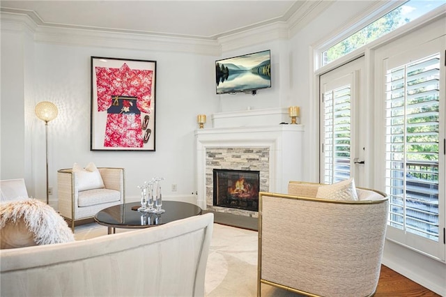 living room featuring ornamental molding, wood finished floors, and a fireplace