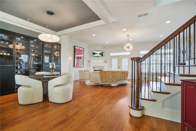 dining space with visible vents, stairs, and ornamental molding