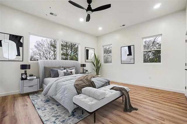 bedroom with light hardwood / wood-style floors and ceiling fan