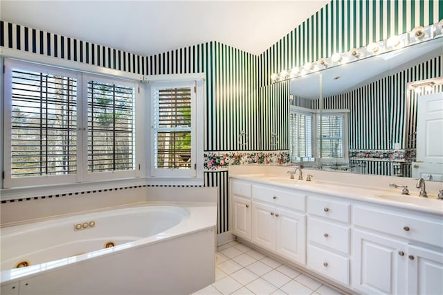 bathroom with tile patterned floors, vanity, and a washtub