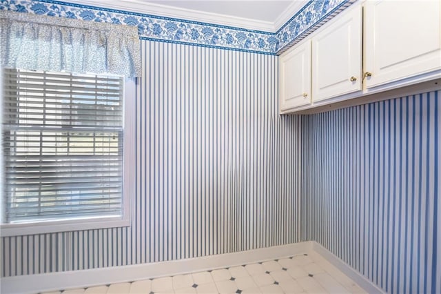 laundry area featuring a wealth of natural light and crown molding