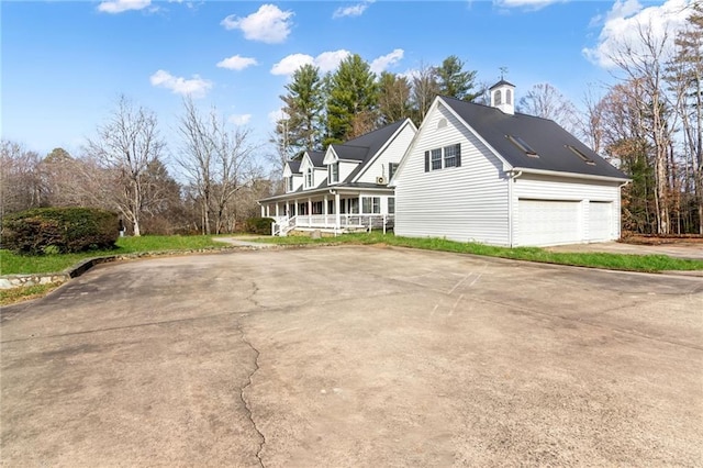 view of home's exterior with a porch and a garage