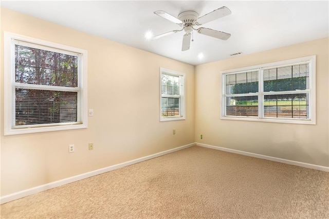 carpeted spare room with ceiling fan