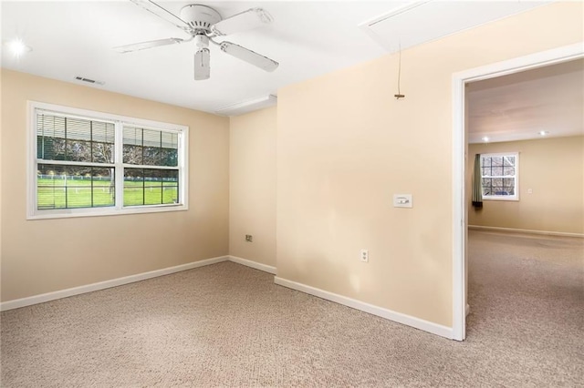 carpeted spare room featuring ceiling fan