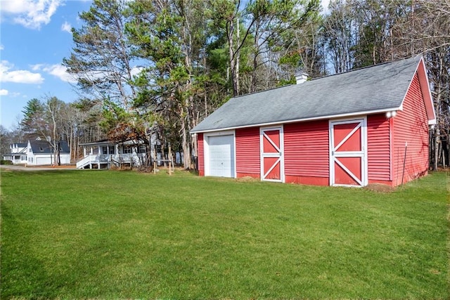 view of outbuilding featuring a yard