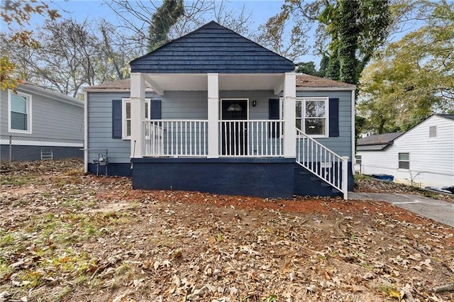 rear view of house featuring a porch