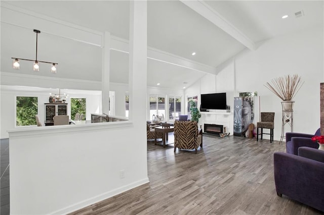 1048 Indian Hills Pkwy, Marietta, GA 30068 - living room with a lit fireplace, wood finished floors, baseboards, and crown molding
