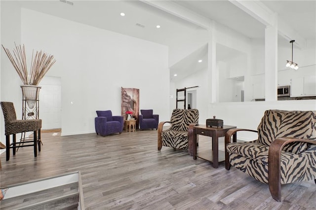 1048 Indian Hills Pkwy, Marietta, GA 30068 - sitting room featuring high vaulted ceiling, wood finished floors, beam ceiling, recessed lighting, and baseboards