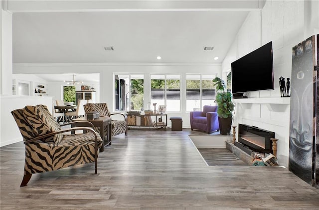 1048 Indian Hills Pkwy, Marietta, GA 30068 - living room featuring lofted ceiling, a glass covered fireplace, wood finished floors, and recessed lighting