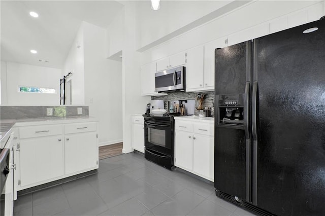 1048 Indian Hills Pkwy, Marietta, GA 30068 - kitchen with black appliances, tasteful backsplash, light countertops, dark tile patterned flooring, and white cabinetry