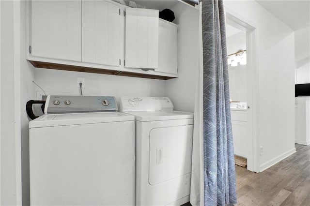 1048 Indian Hills Pkwy, Marietta, GA 30068 - washroom featuring cabinet space, separate washer and dryer, light wood-style flooring, and baseboards