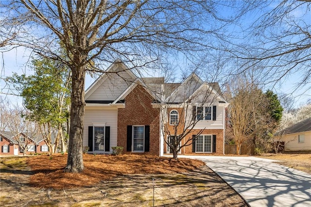 view of front facade featuring brick siding and driveway