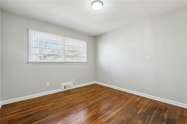 spare room with dark hardwood / wood-style floors