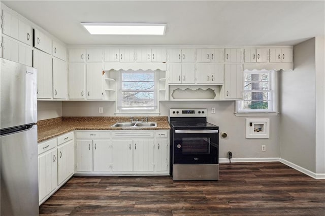 kitchen with sink, white cabinets, appliances with stainless steel finishes, and a wealth of natural light