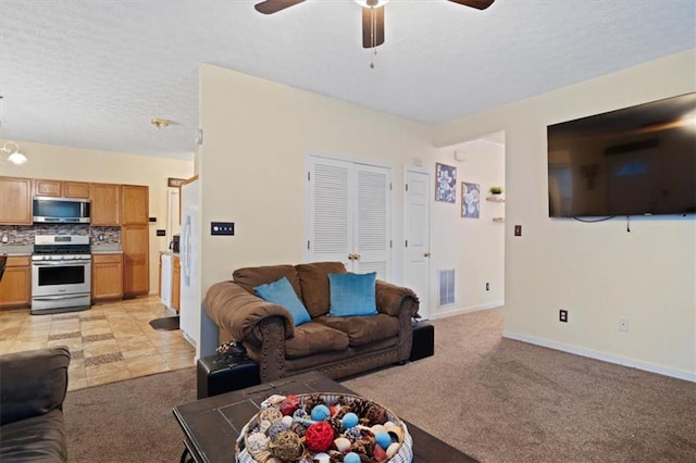 carpeted living room with a textured ceiling and ceiling fan