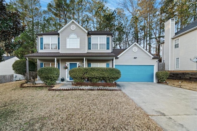 view of front of home featuring a garage, covered porch, and a front yard