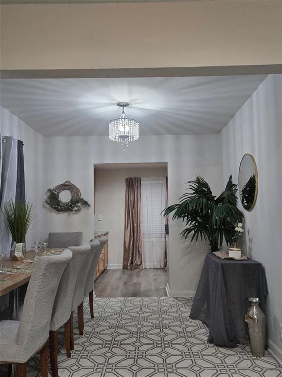 dining area featuring a chandelier and light wood-type flooring